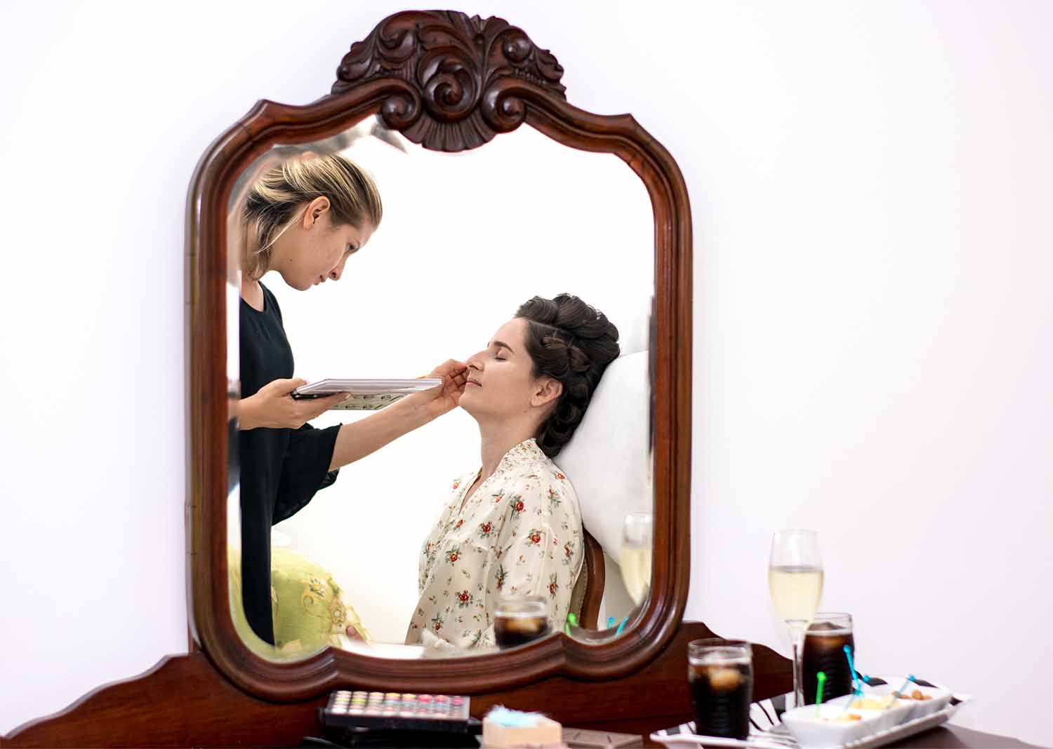 Reflexo da noiva sendo maqueada no espelho